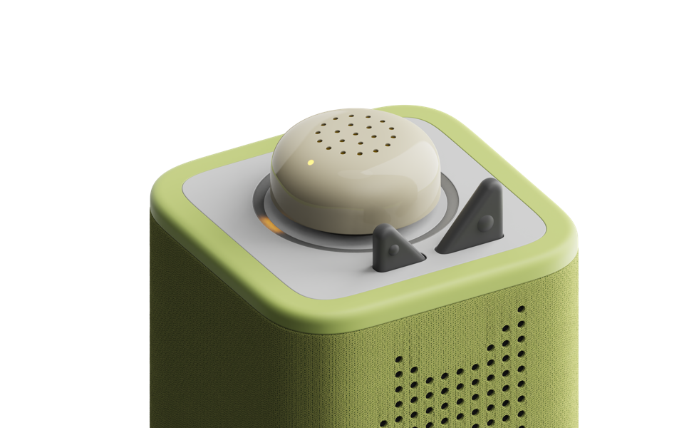 Pale green puck concept with a perforated dome and a small indicator on top of a Toniebox