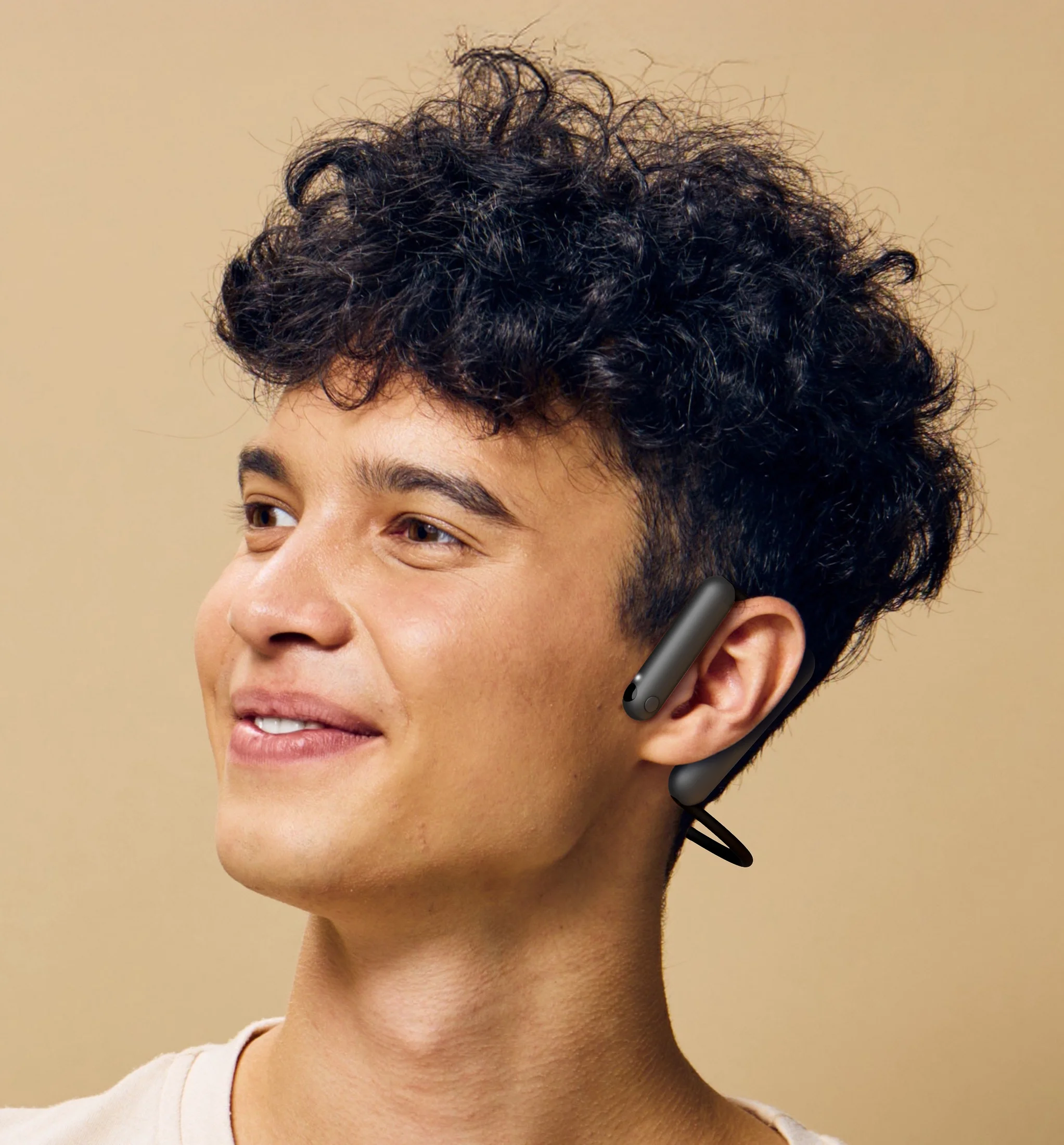 A person wearing the black wearable interface against a warm beige background