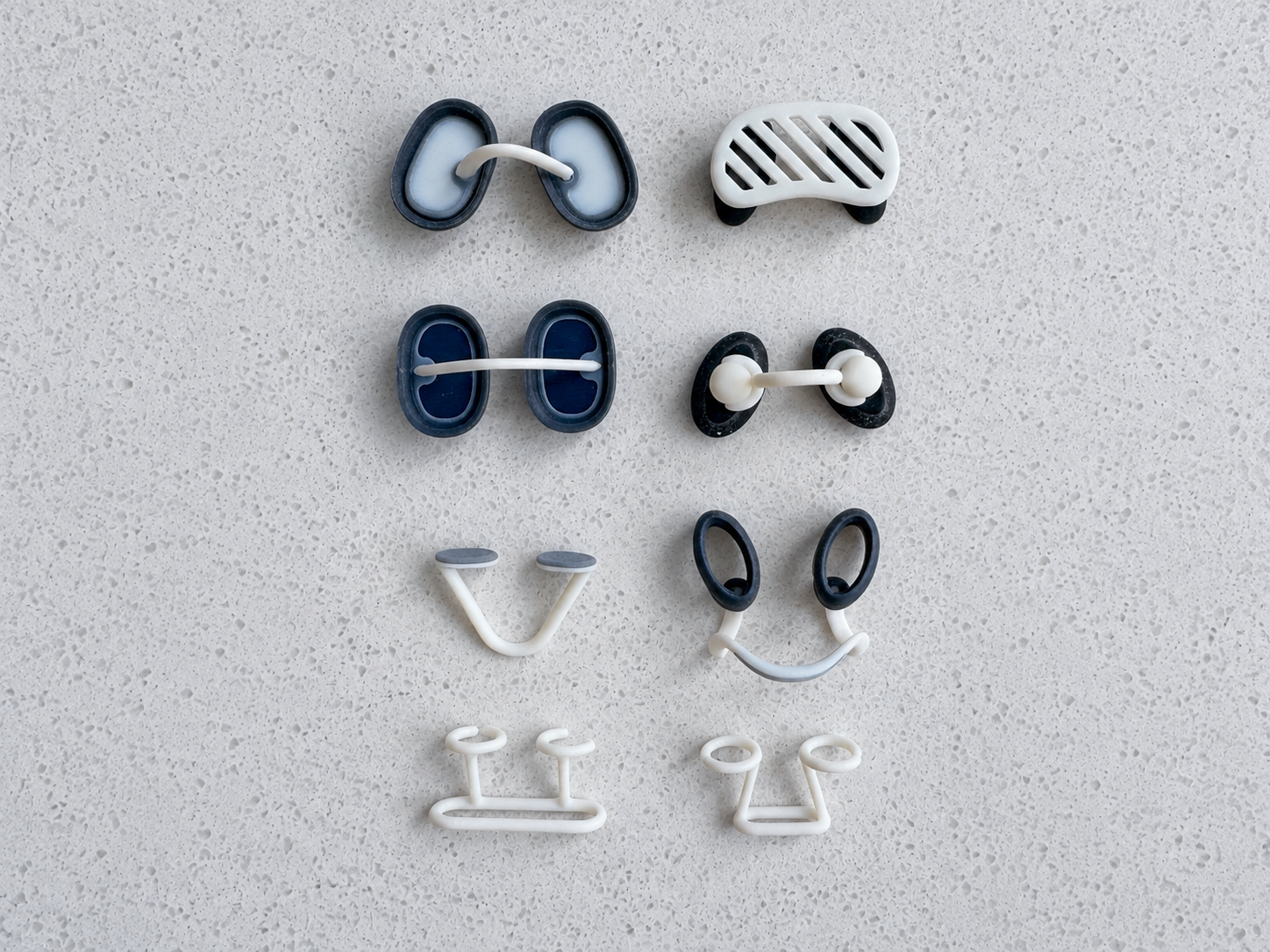 A set of small wearable forms arranged for comparison